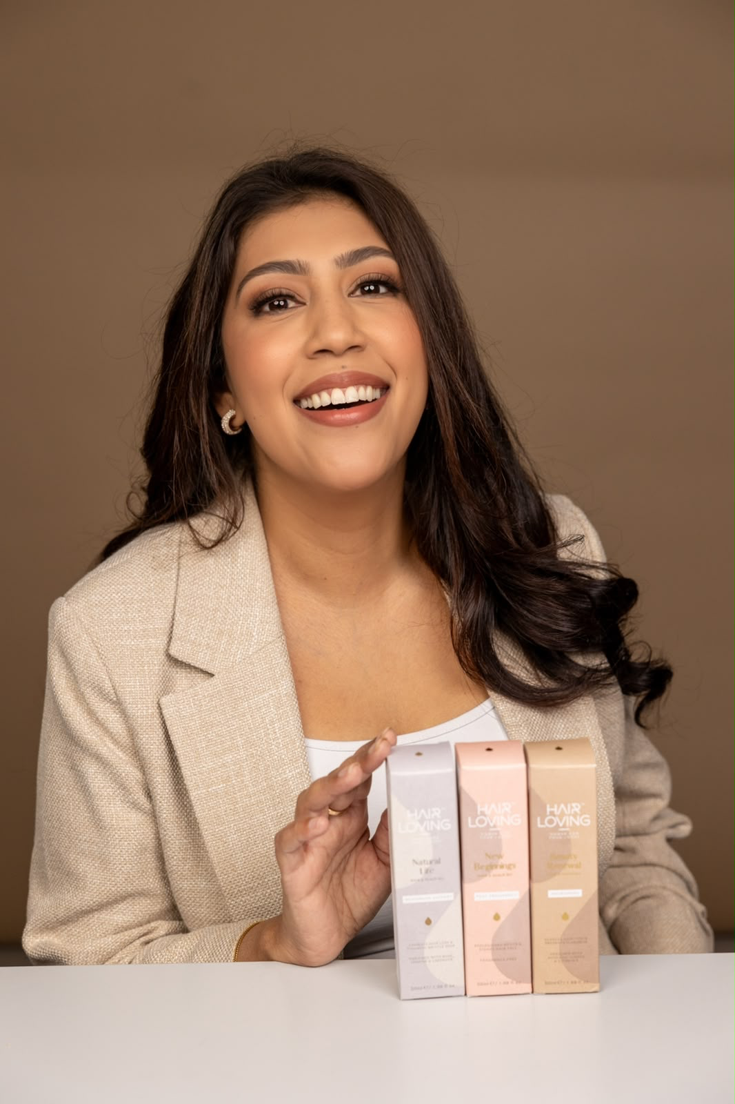Creator presenting haircare packaging boxes